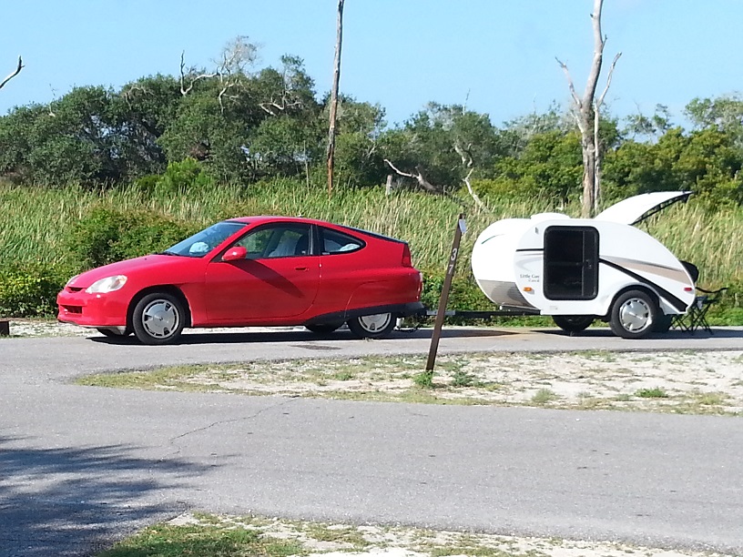 Honda Insight pulling "Little Guy" teardrop trailer.