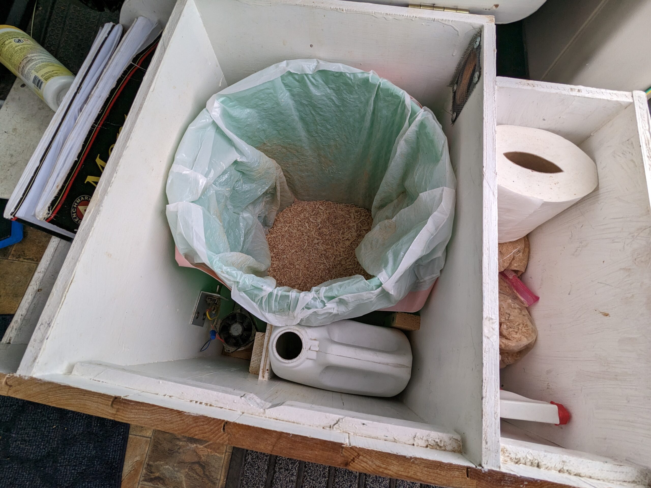 composting toilet with liner and sawdust